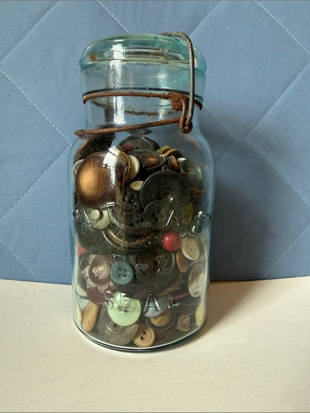 7.5” tall vintage blue glass Atlas jar w/vintage buttons wire close